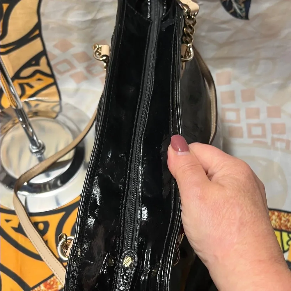 Michael Kors Jet Set Chain Tote in black patent leather with gold hardware.